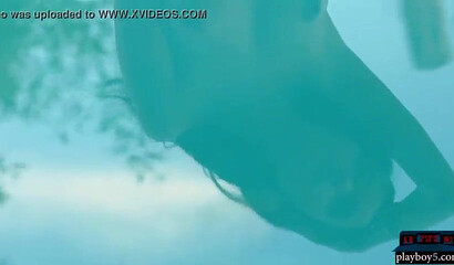 Busty teen beauty shows her round ass and shaved pussy, posing by the swimming pool