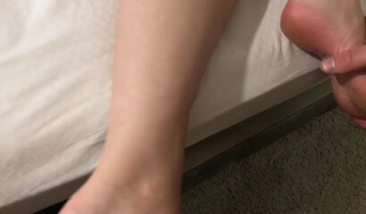 Big ass teen is forced to receive a large wand up her cunt before her feet is covered in cum