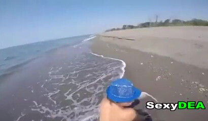 Big bottom teen is sucking a large dick on the beach before her snatch is fucked doggystyle