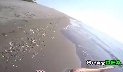 Big bottom teen is sucking a large dick on the beach before her snatch is fucked doggystyle