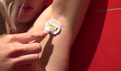 Mature blonde shows her muscles and big ass before she starts shaving her armpits and pussy