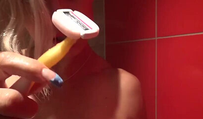 Mature blonde shows her muscles and big ass before she starts shaving her armpits and pussy