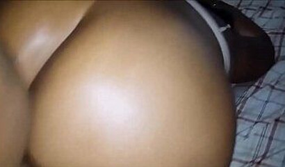 Black babe with an enormous ass takes a hard pounding from the back while squirming gently