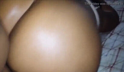 Black babe with an enormous ass takes a hard pounding from the back while squirming gently