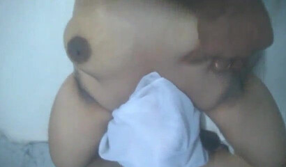 Adorable aunty lays down and massages her big fat ass while making sure that she moans