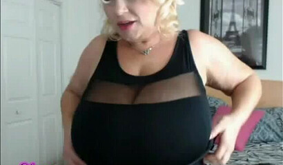 Blonde amateur MILF with short hair shows off enormous tits and fittingly large booty
