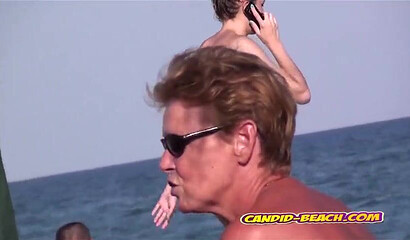 Spying on MILFs with big tits on the sea