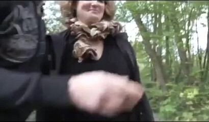 Nasty mature slut stroking dick between her tits in the forest