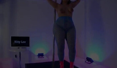 MILF with a fat ass dances around a stripper pole and shows off her juicy pussy and ass