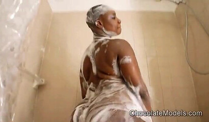 Short haired ebony BBW plays with her massive ass in the showers hoping for a fat cock