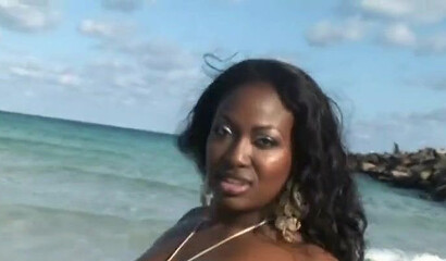 Big booty black babe walks around on the beach and shows off her amazingly thick assets