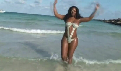 Big booty black babe walks around on the beach and shows off her amazingly thick assets