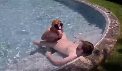 Redhead slut with big tits fucks in the pool
