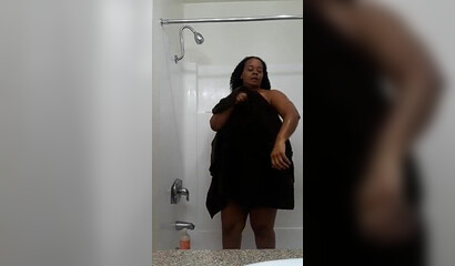 Fat black MILF with big tits shows off her body while showering
