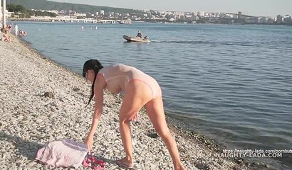 Naughty MILF walking in public in transparent bikini and shows her big tits