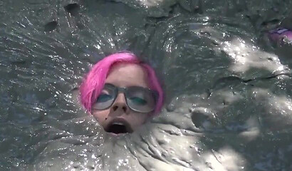 Smoking hot schoolgirl with big boobs swimming in mud