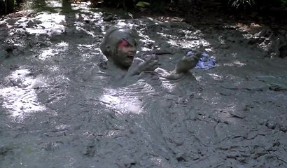 Smoking hot schoolgirl with big boobs swimming in mud