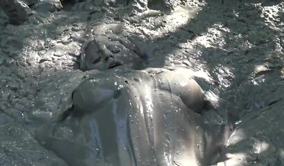 Smoking hot schoolgirl with big boobs swimming in mud