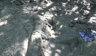 Smoking hot schoolgirl with big boobs swimming in mud