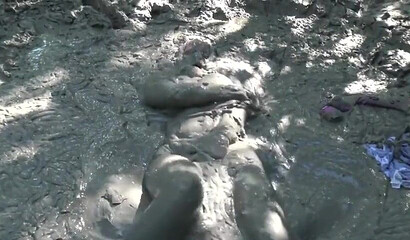 Smoking hot schoolgirl with big boobs swimming in mud