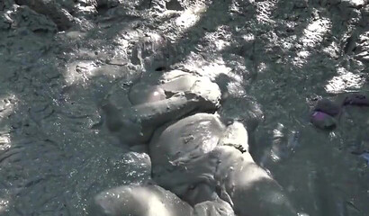 Smoking hot schoolgirl with big boobs swimming in mud