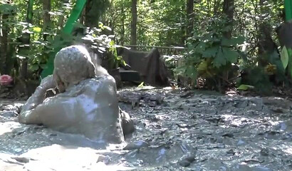 Smoking hot schoolgirl with big boobs swimming in mud