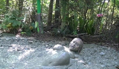 Smoking hot schoolgirl with big boobs swimming in mud