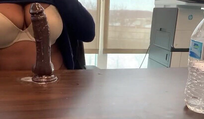 Ebony with big tits and monster butt rides sex toy attached to a table