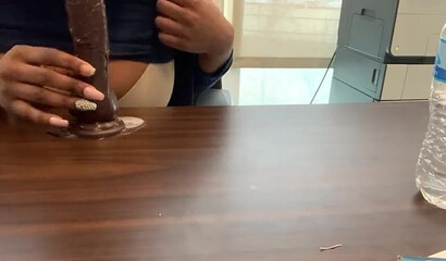 Ebony with big tits and monster butt rides sex toy attached to a table