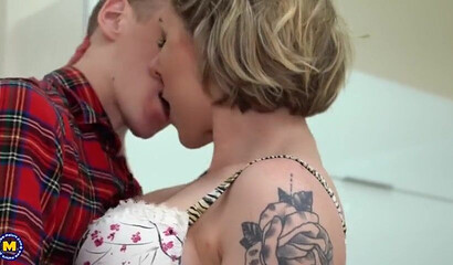 Tattooed milf riding a stiff dick until she cums